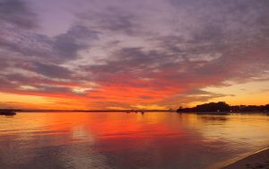 Bright orange and golden sunset over water