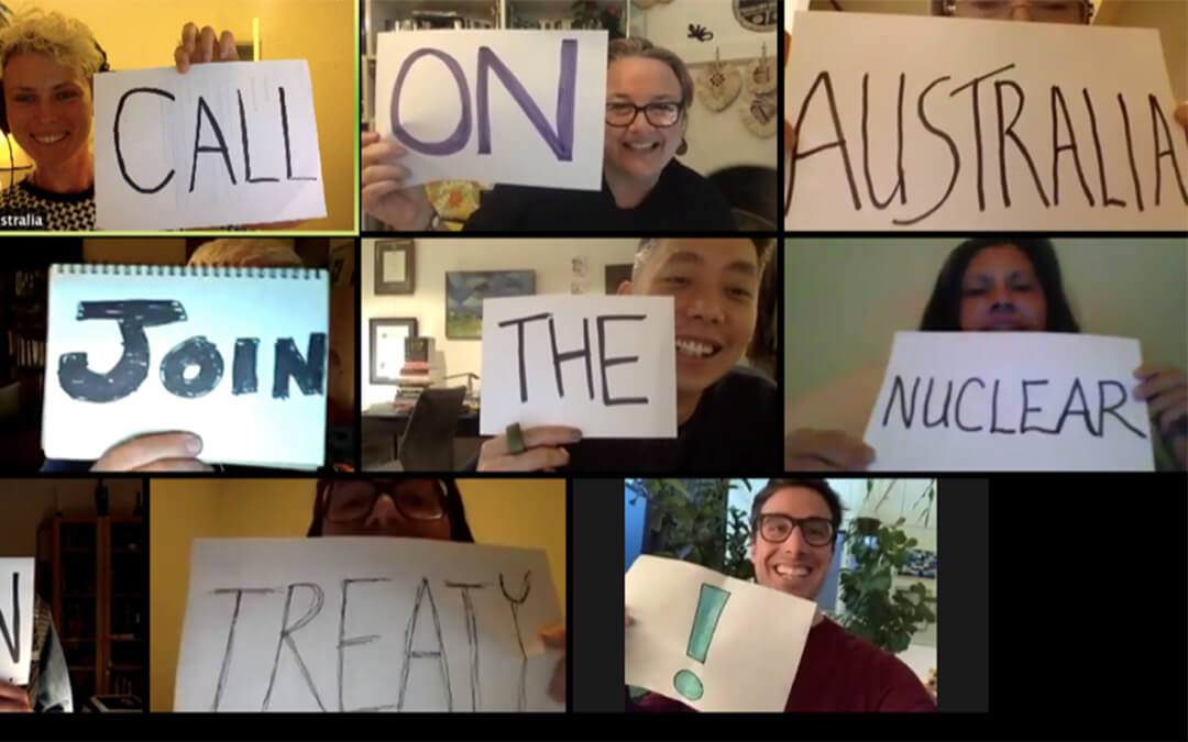 Grid of people holding up signs on computer