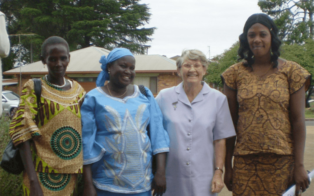 Religious woman standing with four refugee women