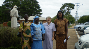 Catholic nun standing with refugees