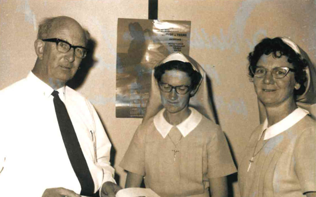 Man standing with two nuns