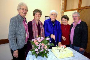 Five women around a cake