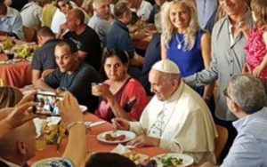 Pope Francis eating with people at the table