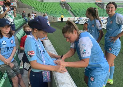 Melbourne City FC player signing t-shirt