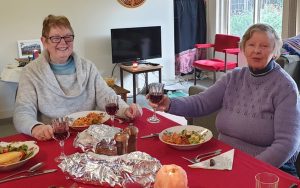 Two women enjoying a meal at the table