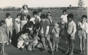 Group of indigenous children in countryside with religious nun