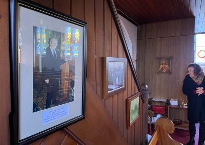 Framed picture of priest on wall in Church