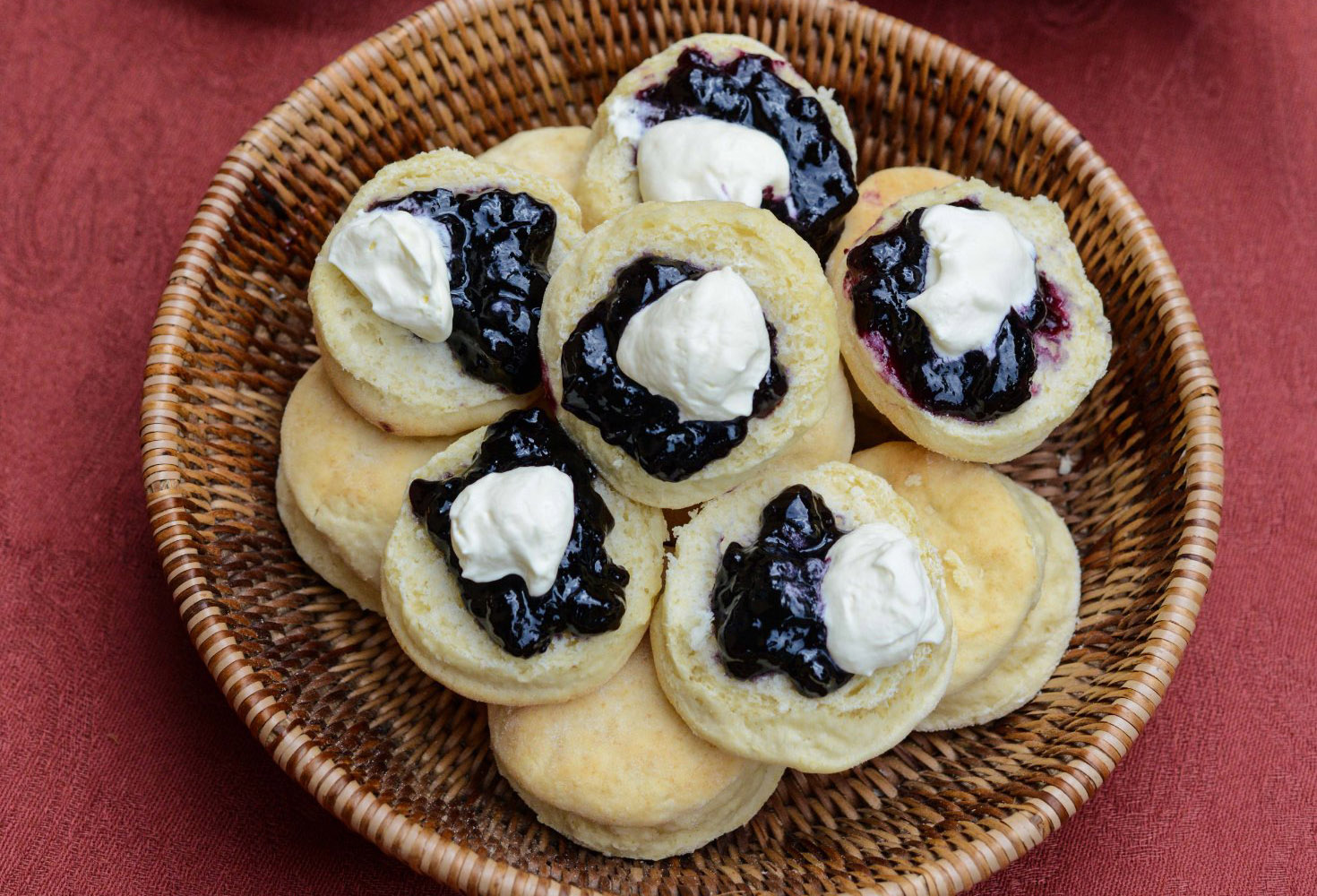 Scones with jam and cream in basket
