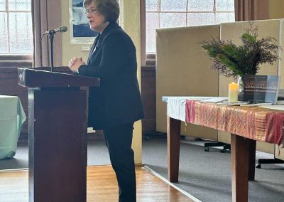 Woman standing at lectern Prue Francis