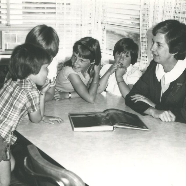 Pat Brain teaching children around a table