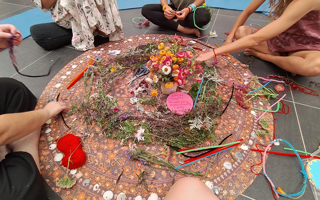 Girls sitting around crafts in a circule