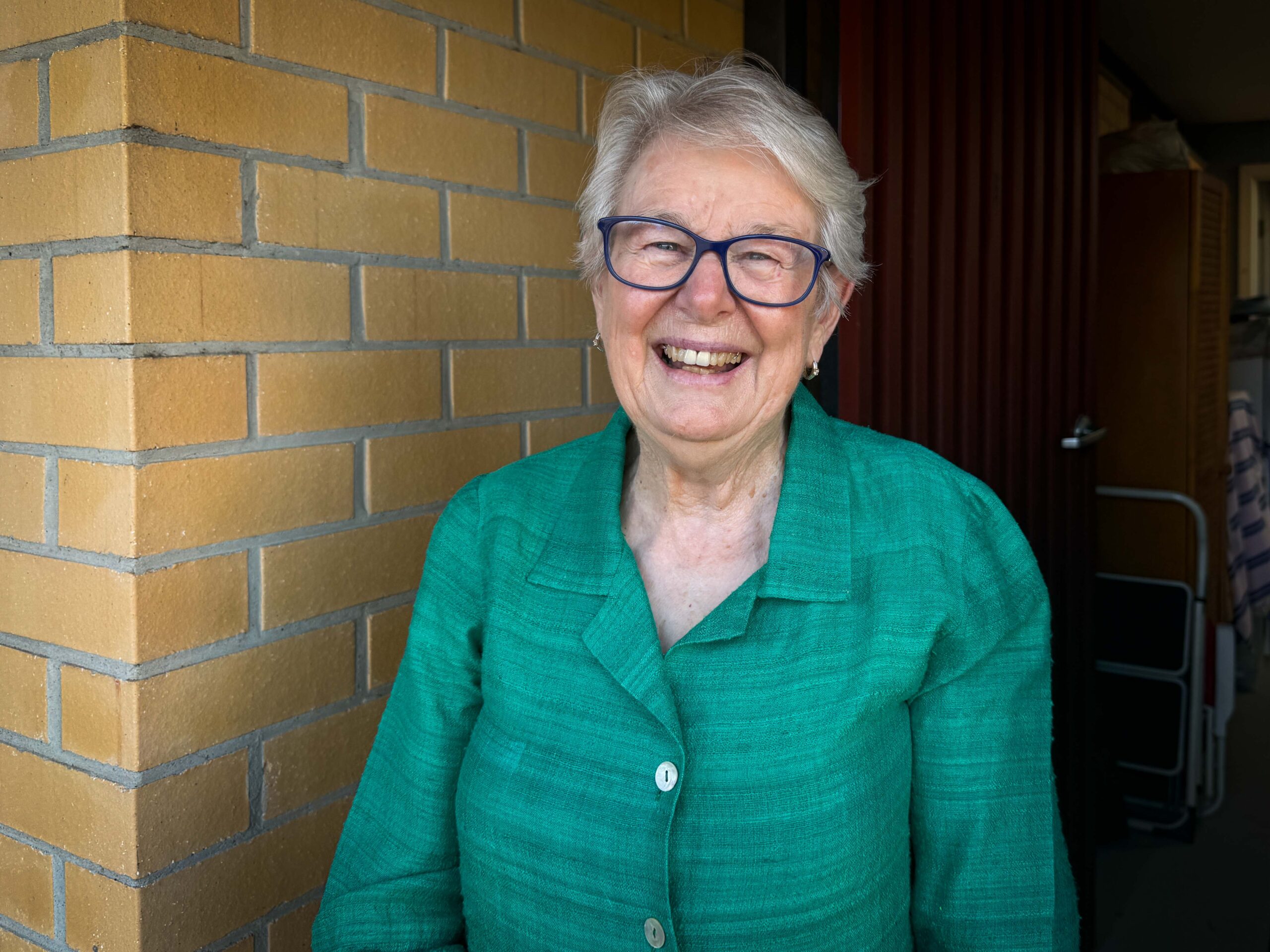 Bernadette Wallis standing in natural light in doorway
