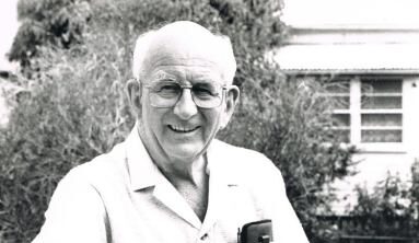 relaxing-on-park-seat Older man sitting on park bench in black and white Fr John Wallis