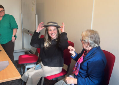 Woman holding old hat on her head